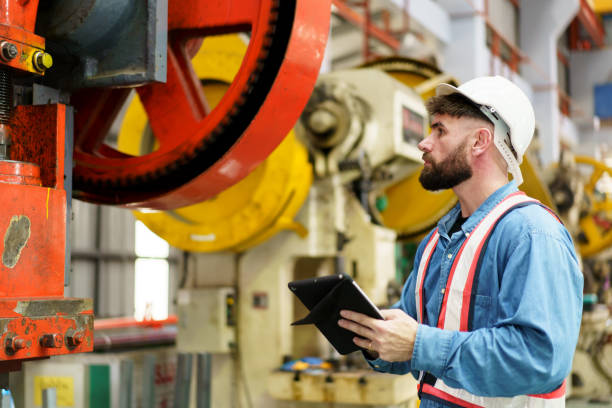 Engineer inspects machinery for heavy equipment repair